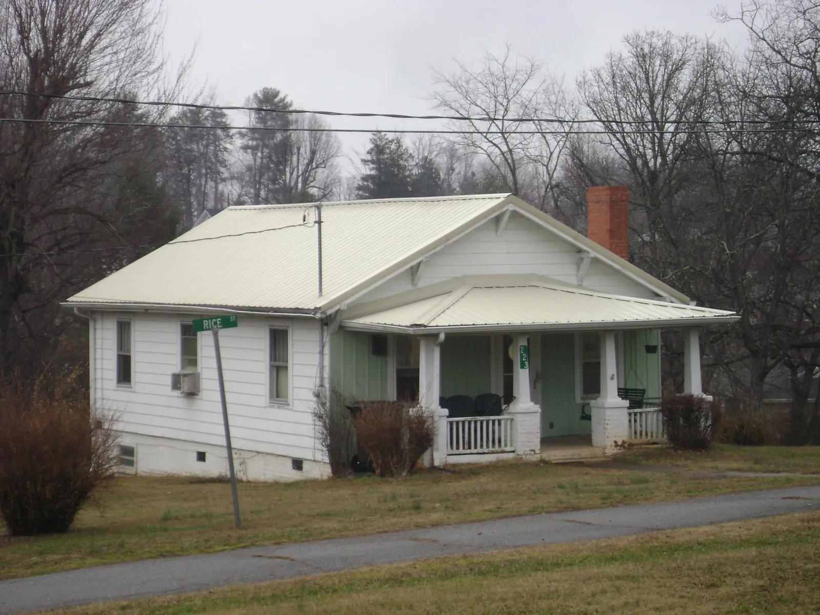 White metal roof on a craftsman bungalow at a street corner in Pembroke Township
